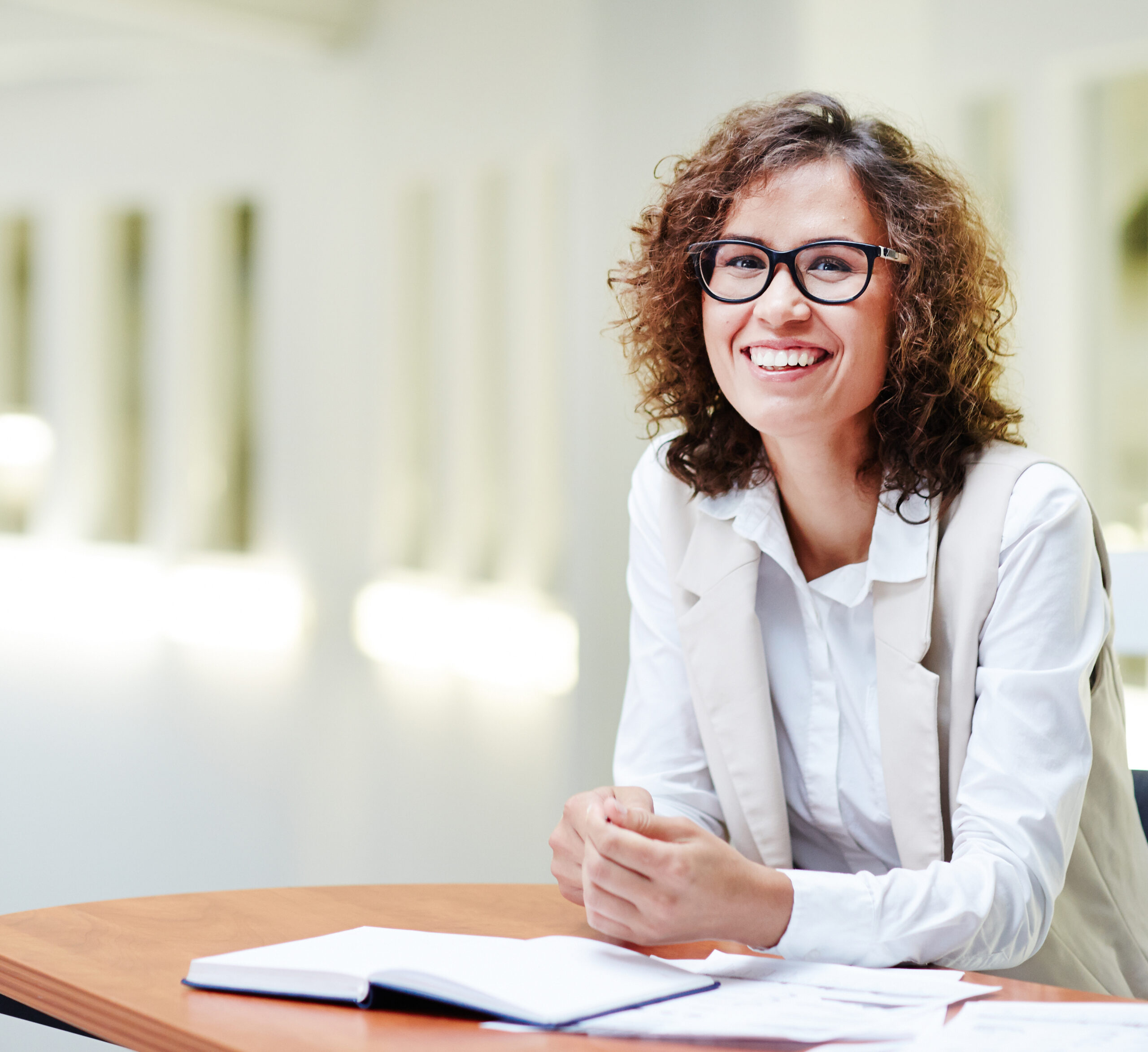 Successful manager in formalwear sitting by her workplace and organizing working day